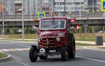 Three Swiss fans arrive in an old-time tractor from home to Kaliningrad stadium, to watch their team playing against Serbia, in Kaliningrad, Russia June 21, 2018. REUTERS/Mariana Bazo