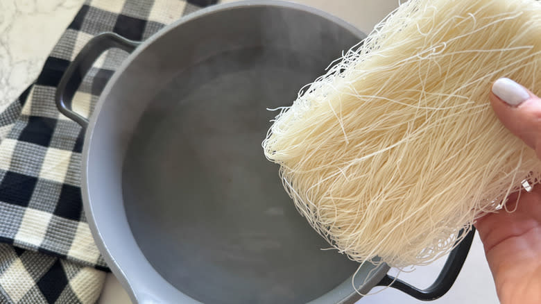 adding noodles to pot