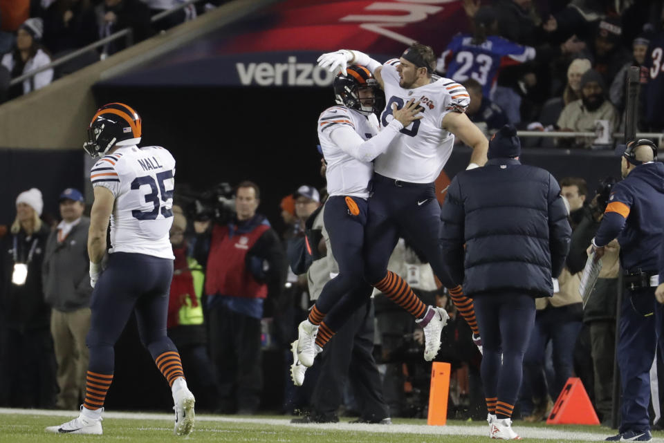 Chicago Bears quarterback Mitchell Trubisky (10) celebrates with Bradley Sowell (85) after Trubisky threw a touchdown pass during the first half of an NFL football game against the Dallas Cowboys, Thursday, Dec. 5, 2019, in Chicago. (AP Photo/Morry Gash)