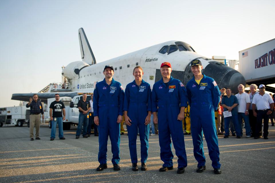 CAPE CANAVERAL - JULY 21:  In this handout image provided by the National Aeronautics and Space Administration (NASA), the STS-135 astronauts (L-R) Mission Specialists Rex Walheim, Sandy Magnus, Pilot Doug Hurley and Commander Chris Ferguson all pose for photographers shortly after they touched down in the space shuttle Atlantis at NASA's Kennedy Space Center Shuttle Landing Facility July 21, 2011 in Cape Canaveral, Florida. Space shuttle Atlantis was on a 12-day mission to the International Space Station where it delivered the Raffaello multi-purpose logistics module packed with supplies and spare parts. This was the final mission of the space shuttle program, which began on April 12, 1981 with the launch of Colombia.  (Photo by Bill Ingalls/NASA via Getty Images)