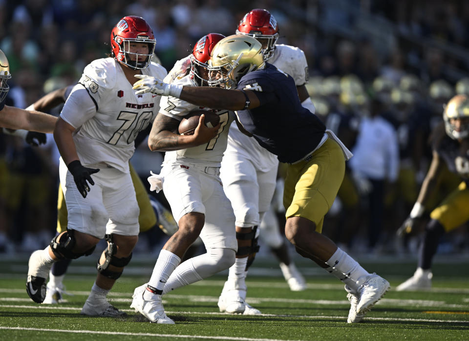 UNLV quarterback Cameron Friel (7) is sacked by Notre Dame defensive lineman Isaiah Foskey (7) during the second half of an NCAA college football game, Saturday, Oct. 22, 2022, in South Bend, Ind. (AP Photo/Marc Lebryk)