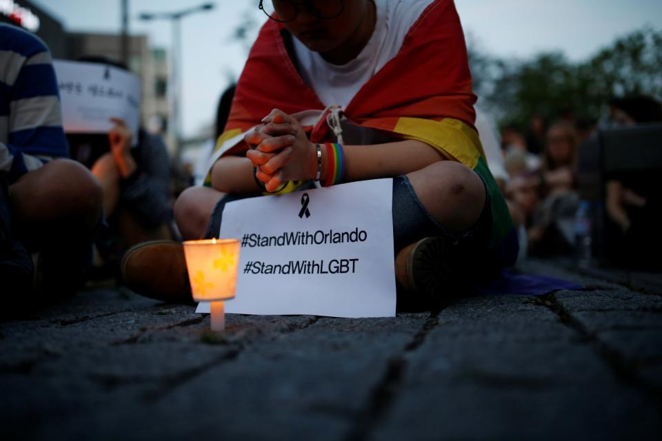 <p>A woman prays during a candlelight vigil in solidarity for the victims of the Orlando gay nightclub mass shooting, in Seoul, South Korea, June 13, 2016. (Kim Hong-Ji/Reuters) </p>