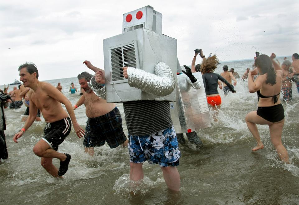 NEW YORK, NY - JANUARY 1: People wearing costumes take part in the Coney Island Polar Bear Club's New Year's Day swim on January 1, 2013 in the Coney Island neighborhood of the Brooklyn borough of New York City. The annual event attracts hundreds who brave the icy Atlantic waters and temperatures in the upper 30's as a way to celebrate the first day of the new year. (Photo by Monika Graff/Getty Images)