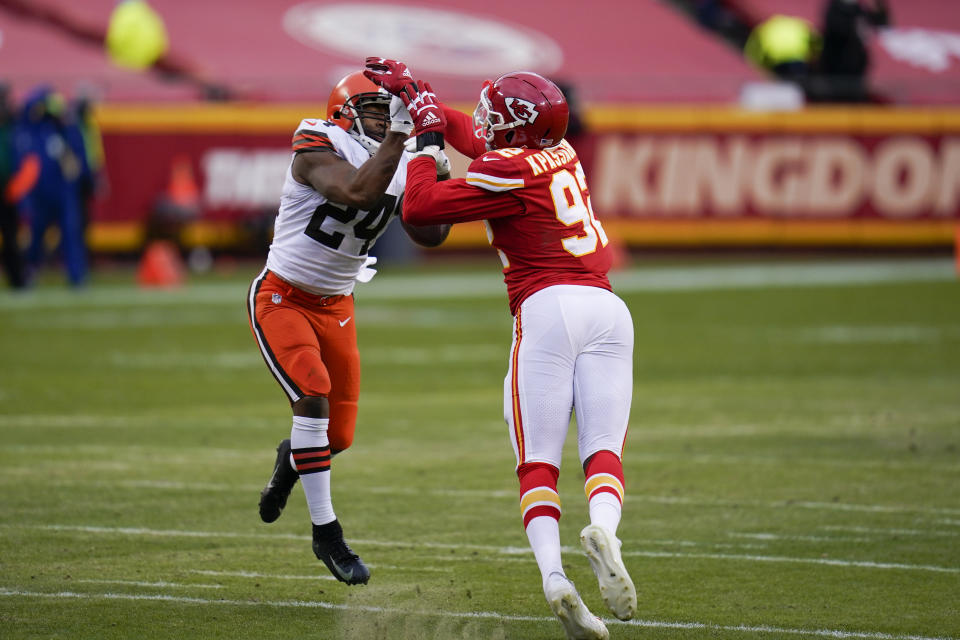 Kansas City Chiefs defensive end Tanoh Kpassagnon breaks up a pass intended for Cleveland Browns running back Nick Chubb (24) during the second half of an NFL divisional round football game, Sunday, Jan. 17, 2021, in Kansas City. (AP Photo/Jeff Roberson)