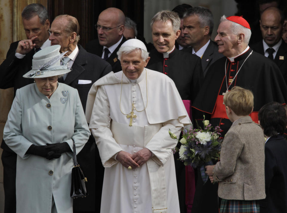 FILE - Britain's Queen Elizabeth II, left, accompanies Pope Benedict XVI as he leaves the Palace of Holyroodhouse in Edinburgh, Scotland, on Sept. 16, 2010. Pope Emeritus Benedict XVI, the German theologian who will be remembered as the first pope in 600 years to resign, has died, the Vatican announced Saturday. He was 95. (AP Photo/Lefteris Pitarakis, pool, File)
