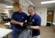 Sam Daniels (L) and Mike Evans of the International Association of Machinists and Aerospace Workers, shake hands at IAM headquarters after workers rejected union representation at the Boeing South Carolina plant in North Charleston, South Carolina, U.S. February 15, 2017. REUTERS/Randall Hill