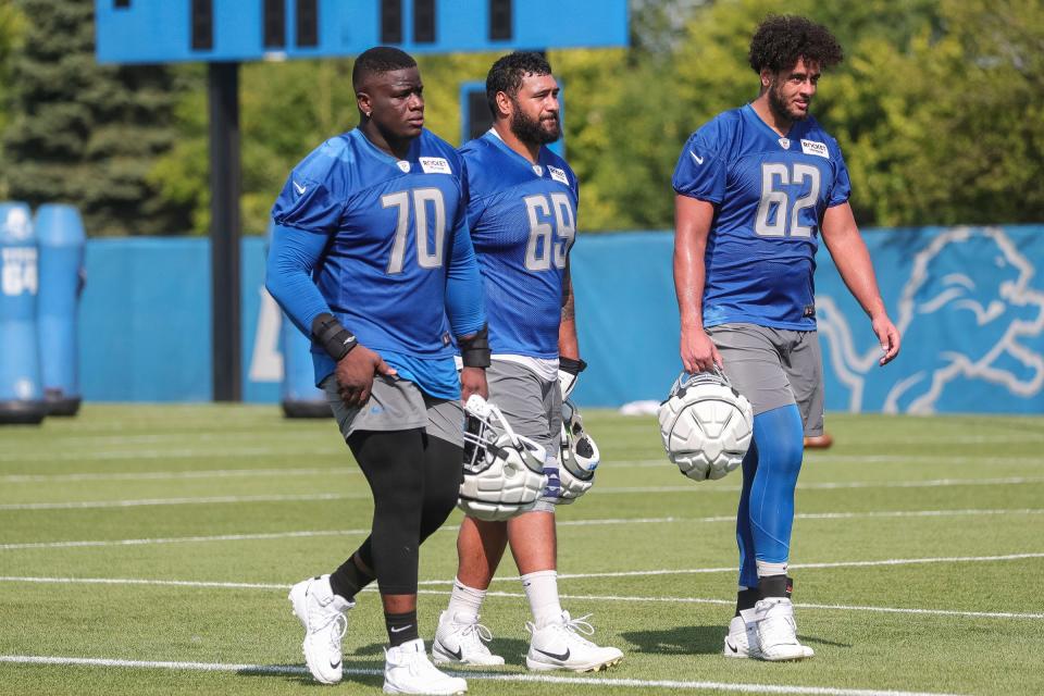 From left, Detroit Lions guard Germain Ifedi (70), tackle Darrin Paulo (69) and offensive tackle Ryan Swoboda (62) after practice during training camp at the Detroit Lions Headquarters and Training Facility in Allen Park on Sunday, July 23, 2023.