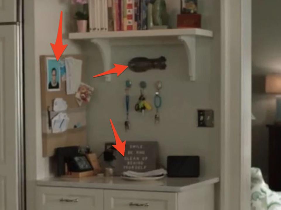 the fisher kitchen with arrows pointing to a photo of ruth bader ginsberg, a wooden fish, and a sign saying please clean up - summer i turned pretty