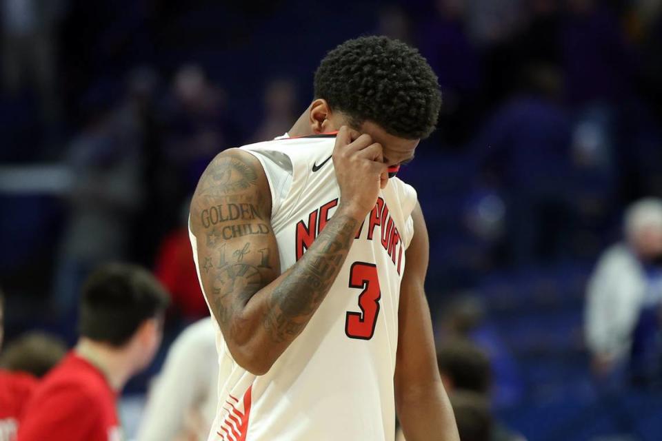 Newport’s DeShaun Jackson (3) leaves the court dejected after the Wildcats were defeated in the opening round by Campbell County. James Crisp