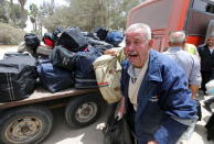 A Palestinian man cries out of joy after retuning to Gaza through Rafah border crossing between Egypt and southern Gaza Strip May 26, 2015. REUTERS/Ibraheem Abu Mustafa