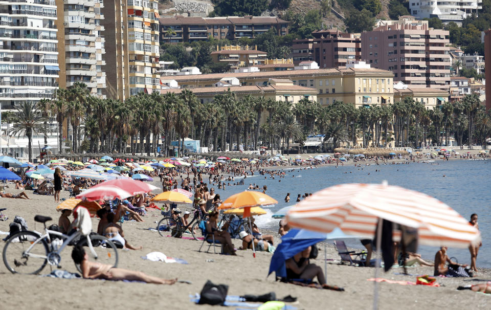 Bathers enjoy the beach of La Malagueta in Malaga, Spain.  Source: Getty