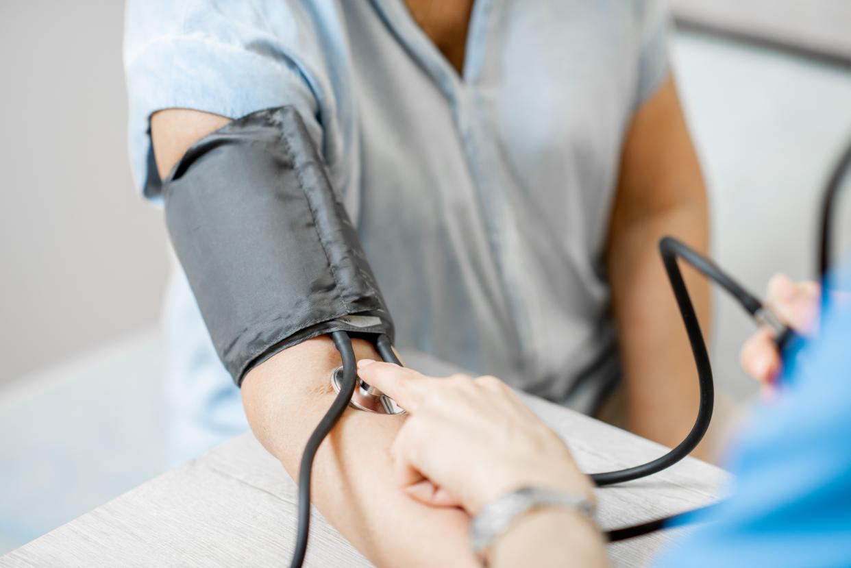 Nurse measuring blood pressure of a senior patient