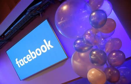 FILE PHOTO: Balloons are seen in front of a logo at Facebook's headquarters in London, Britain, December 4, 2017. REUTERS/Toby Melville/File Photo