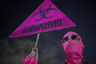 A protester holds a banner against Israeli Prime Minister Benjamin Netanyahu and the coronavirus countrywide lockdown in Tel Aviv, Israel, Thursday, Sept. 17, 2020. Netanyahu's government has imposed a three-week lockdown, beginning on Friday afternoon. (AP Photo/Ariel Schalit)