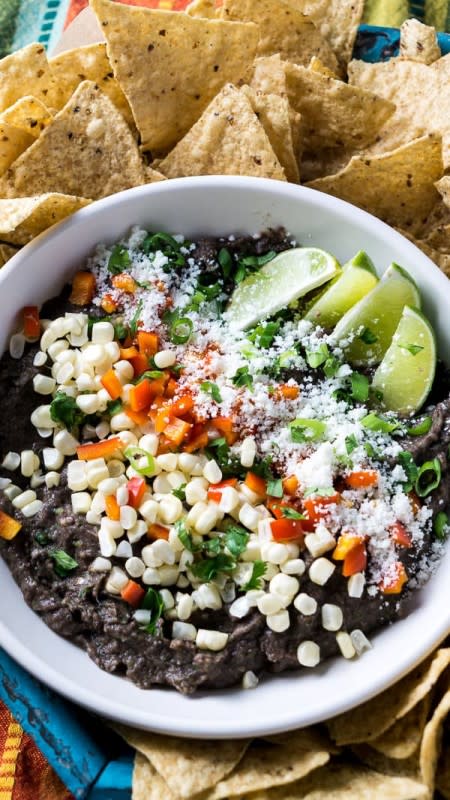 <p>The Kitchen Girl</p><p>This Loaded Black Bean Dip is the easiest party food you’ll ever make! It’s a simple 10-minute Mexican black bean dip garnished with fresh produce and Cotija cheese. It’s naturally gluten-free and vegetarian!</p><p><strong>Get the Recipe: </strong><a href="https://thekitchengirl.com/loaded-black-bean-dip/" rel="nofollow noopener" target="_blank" data-ylk="slk:Loaded Black Bean Dip;elm:context_link;itc:0;sec:content-canvas" class="link ">Loaded Black Bean Dip</a></p>