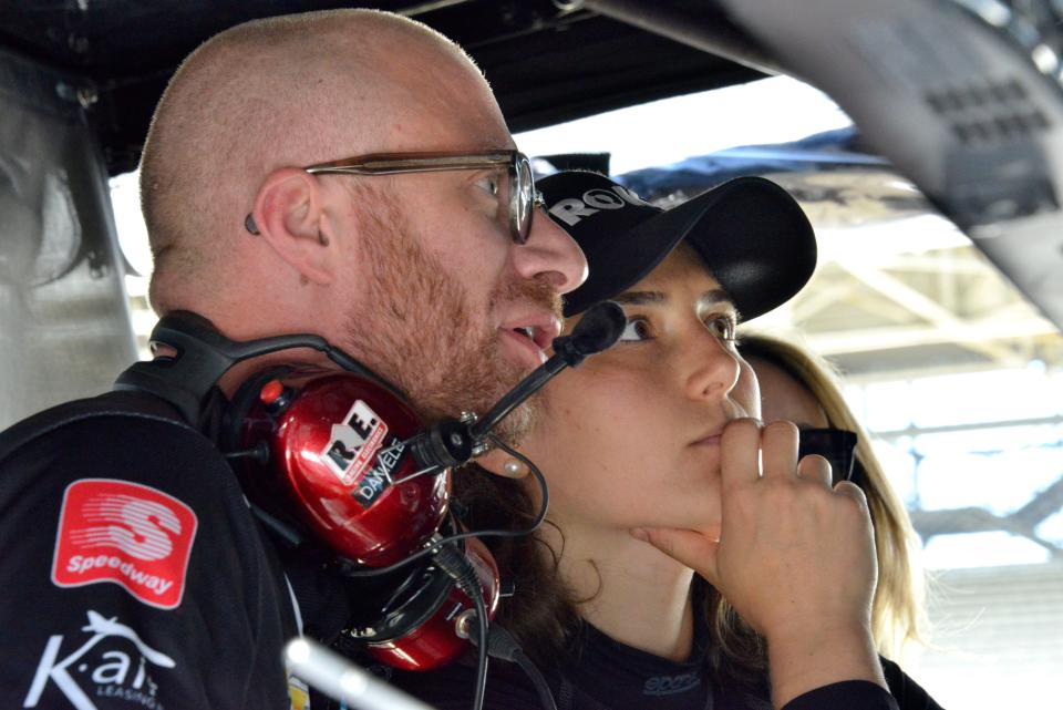 A. J. Foyt Enterprises driver Tatiana Calderon (11) talks with her crew Friday, May 13, 2022, during practice for the GMR Grand Prix at Indianapolis Motor Speedway. 