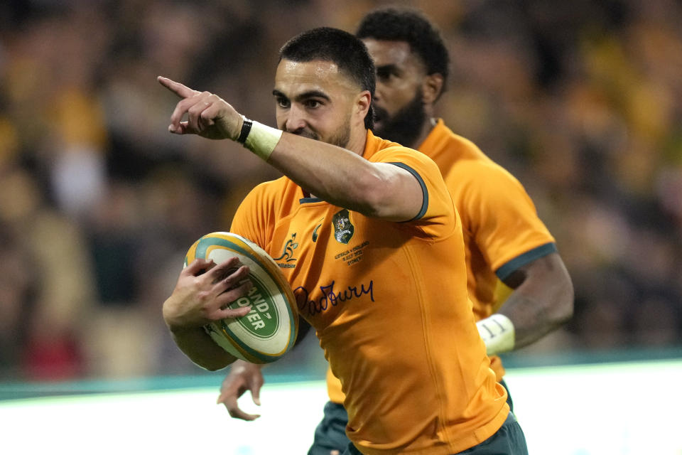 Australia's Tom Wright points as he runs in to score a try against England during their rugby union test match in Sydney on Saturday, July 16, 2022(AP Photo/Rick Rycroft)