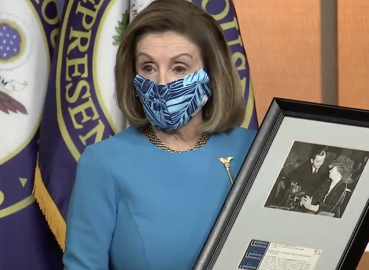 House Speaker Nancy Pelosi holds up a photograph of her father meeting Eleanor Roosevelt as the House prepared to vote on Washington DC statehood, which Ms Pelosi said is in her ‘DNA’. (House Speaker)