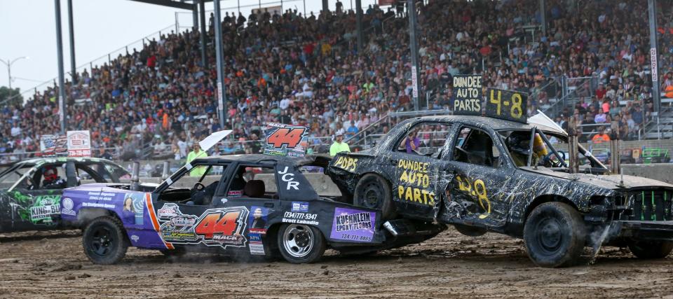 Eric Mack, of MOnroe in car 48, drives under the car of Josh Sweigert , of Dundee, Tuesday evening in the Demolition Derby at the Monroe County Fair.