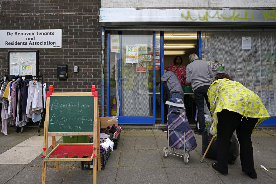 People line up at the Community Food Hub in Hackney, London, Thursday, June 13, 2024. Since calling a general election, British Prime Minister Rishi Sunak has been at pains to repeat a key message on the campaign trail: The economy is turning a corner, inflation is down, and things are looking up. That’s not the reality for millions across the U.K. still feeling the squeeze from high food, energy and housing prices. (AP Photo/Kin Cheung)