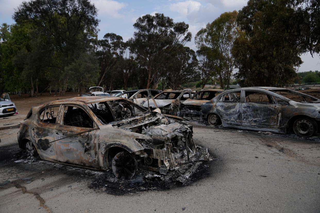 Destroyed cars are seen at the rave party site near the Kibbutz Re’im, close to the Gaza Strip border fence on Tuesday (AP)