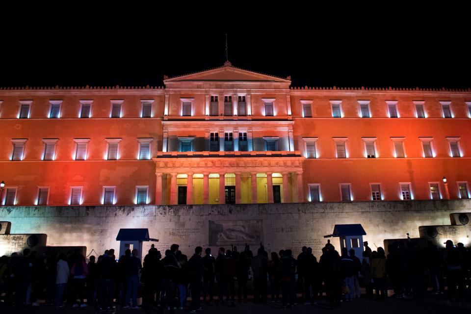 <p>The Greek parliament is illuminated in orange for the International Day for the Elimination of Violence Against Women, on Nov. 25, 2017 in Athens. (Photo: Angelos Tzortzinis/AFP/Getty Images) </p>