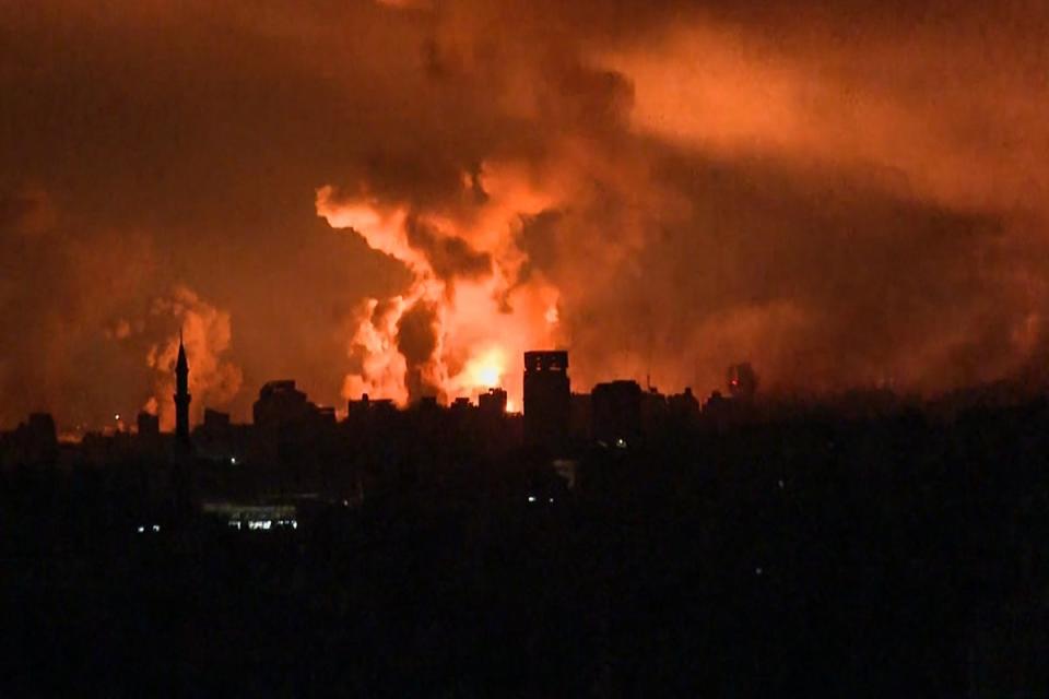 Balls of fire rise above Gaza City on Friday during an Israeli strike (AFP)