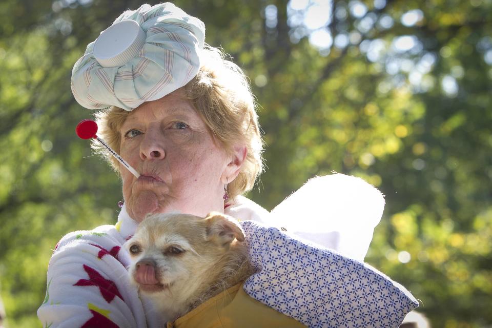 A woman poses for a photo with her dog during the 24th Annual Tompkins Square Halloween Dog Parade in New York