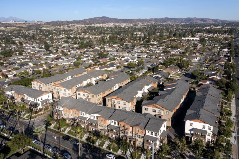 Yorba Linda, CA - November 24: An aerial view of the Heritage Crossings 3-story condo and apartment buildings at center of photo, built in 2016, amidst a community mostly consisting of single-story, single family houses on Wednesday, Nov. 24, 2021. Orange County cities are pushing back against state requirements for regions to build more dense housing projects. (Allen J. Schaben / Los Angeles Times)