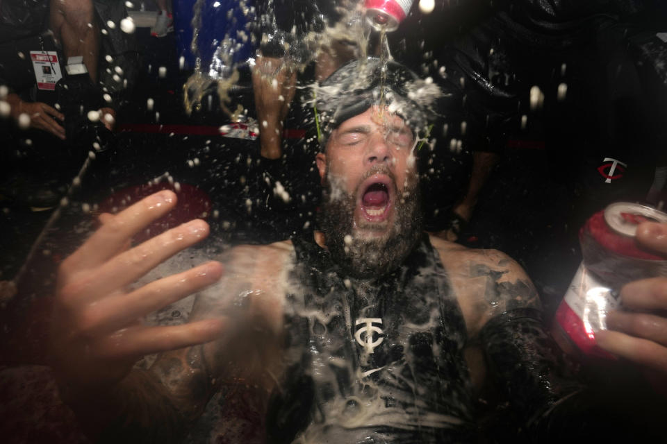 Minnesota Twins' Dallas Keuchel celebrates after the team clinched the AL Central title with an 8-6 win over the Los Angeles Angels in a baseball game Friday, Sept. 22, 2023, in Minneapolis. (AP Photo/Abbie Parr)