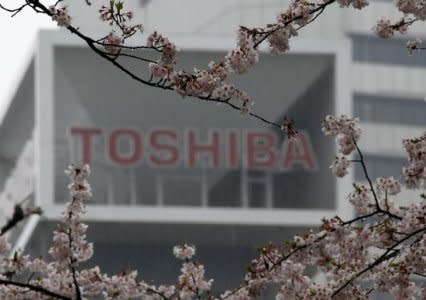 FILE PHOTO -The logo of Toshiba Corp is seen behind cherry blossoms at the company's headquarters in Tokyo, Japan April 11, 2017. REUTERS/Toru Hanai