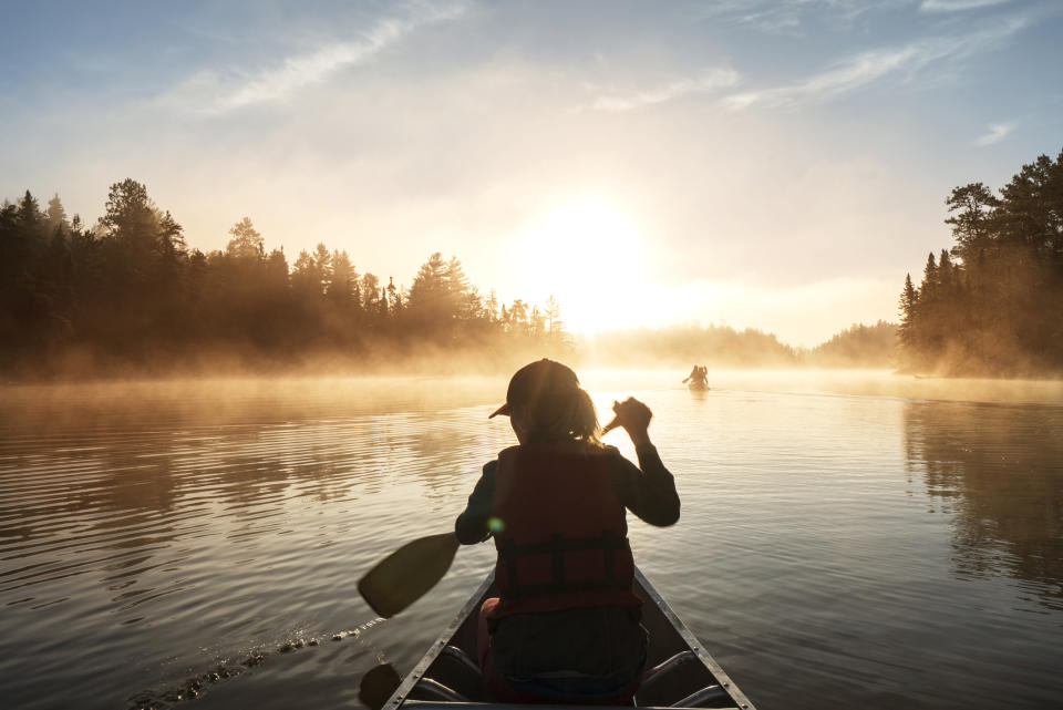 Rear view of woman traveling in boat on lake in Minnesota