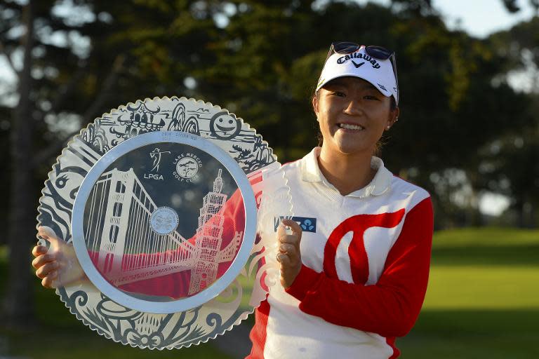 Lydia Ko of New Zealand poses with the winner's trophy after winning the Swinging Skirts LPGA Classic, at the Lake Merced Golf Club in Daly City, California, on April 26, 2015