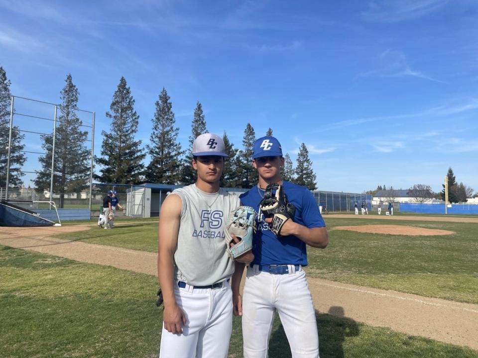 (Left) Ben Loza, senior infielder for Bear Creek and (right) Ethan Silva, freshman infielder for Bear Creek pose for a photo during the team's practice at Bear Creek High School.