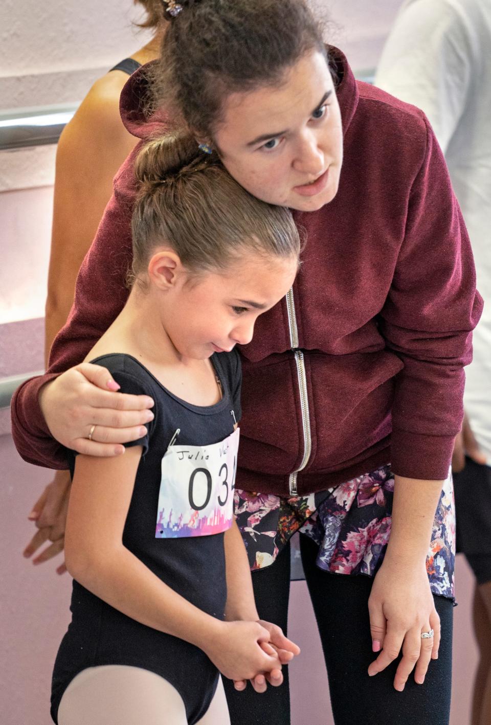 Julia Vest, left, is comforted by Audition Director Bogdana Кopiy at the start of auditions Wednesday, Sept. 28, 2022 at Fox Hill Dance Academy. Children 6-17 in age auditioned to dance with professional dancers from around the world in the Dance With Us community engagement opportunity offered by the NUTCRACKER! Magical Christmas Ballet troupe. They hope get roles as mice, snowflakes, snow maidens, party guests or other dancer variations. Julia had to leave but still got a small part in the show.