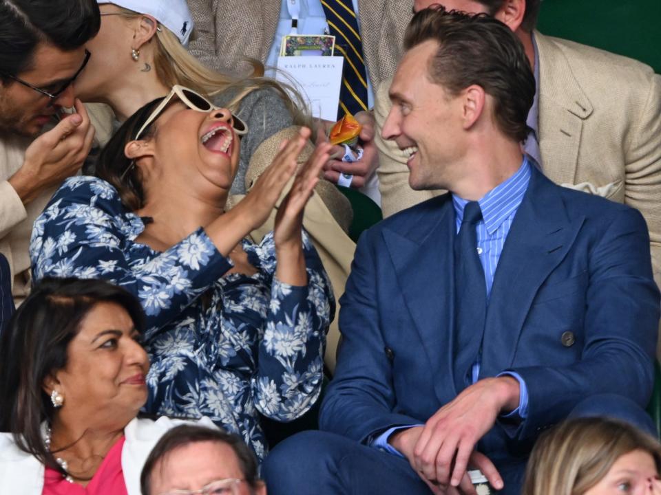 Zawe Ashton and Tom Hiddleston laugh at Wimbledon 2023.