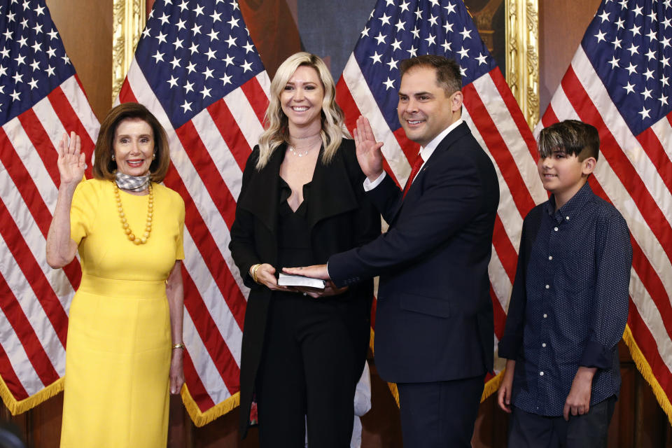 House Speaker Nancy Pelosi of Calif., left, conducts a ceremonial swearing-in for Rep. Mike Garcia, R-Calif., second from right, joined by his wife Rebecca and son Preston, on Capitol Hill in Washington, Tuesday, May 19, 2020. (AP Photo/Patrick Semansky)