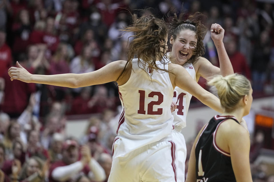 Indiana's Yarden Garzon (12) and Mackenzie Holmes celebrate as Nebraska's Jaz Shelley (1) walks past during overtime of an NCAA college basketball game, Sunday, Jan. 1, 2023, in Bloomington, Ind. (AP Photo/Darron Cummings)