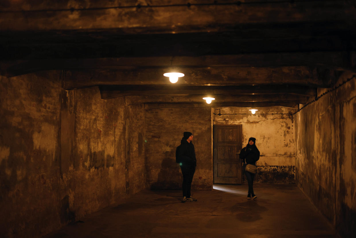 People visit the former gas chamber at the former Nazi German concentration and extermination camp Auschwitz-Birkenau in Oswiecim, Poland, Thursday, Jan. 26, 2023. Survivors of Auschwitz-Birkenau are gathering to commemorate the 78th anniversary of the liberation of the Nazi German death camp in the final months of World War II, amid horror that yet another war has shattered the peace in Europe. The camp was liberated by Soviet troops on Jan. 27, 1945. (AP Photo/Michal Dyjuk)