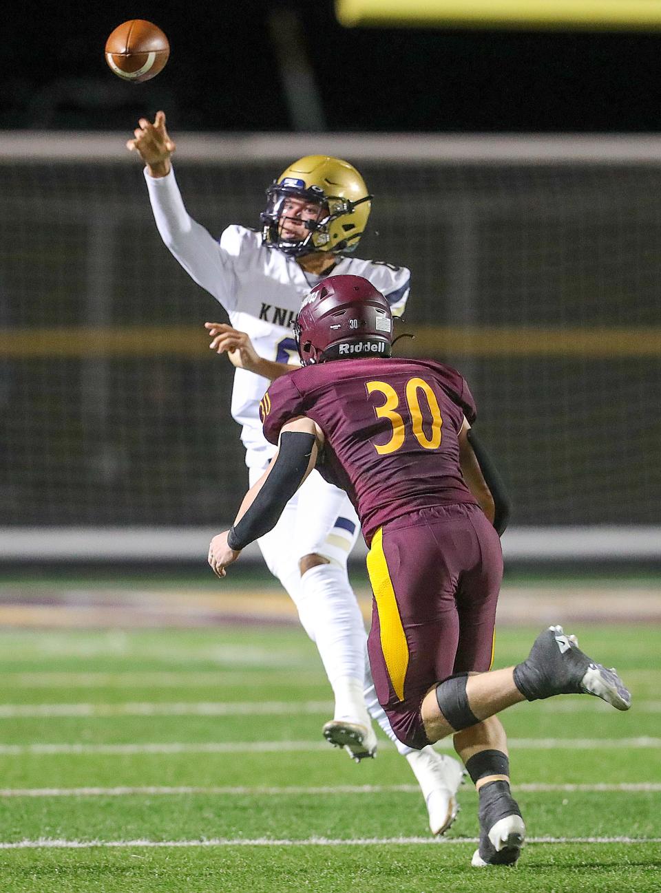 Hoban quarterback Jacqai Long gets off a pass under pressure from Walsh Jesuit's Brock Sherman  on Friday, Sept. 23, 2022 in Cuyahoga Falls.