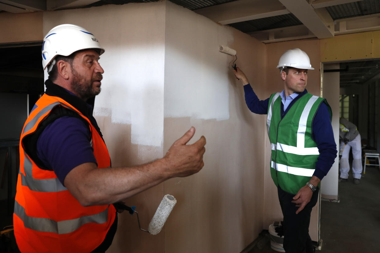  Prince William speaks with presenter Nick Knowles as he helps to renovate homes as part of the BBC television DIY SOS series