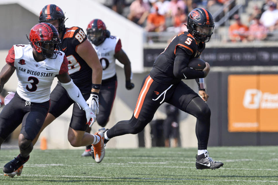 Oregon State quarterback DJ Uiagalelei (5) rushes in front to San Diego State safety Cedarious Barfield (3) during the first half of an NCAA college football game Saturday, Sept. 16, 2023, in Corvallis, Ore. (AP Photo/Mark Ylen)
