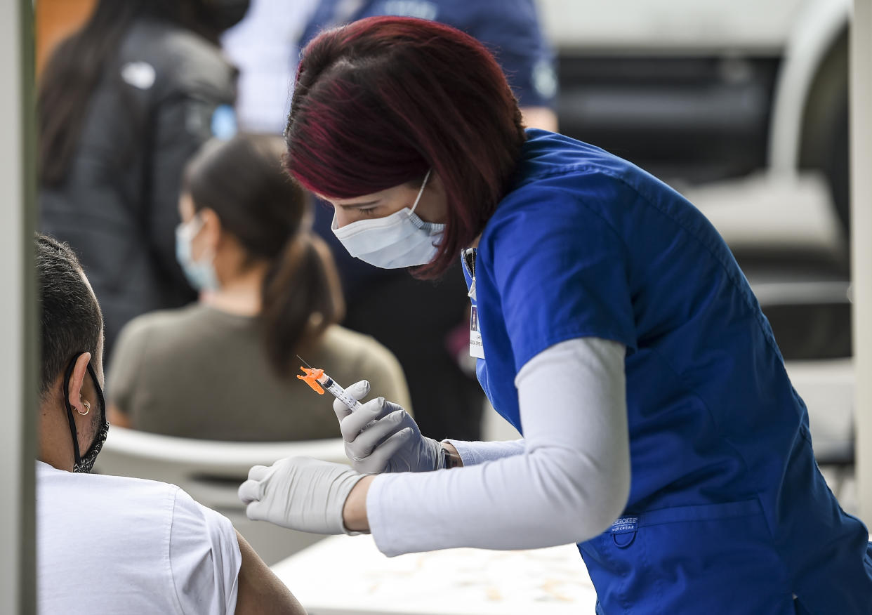 Reading, PA - April 19: Christy Daniels gives a dose of COVID-19 vaccine. During a CATE mobile COVID-19 Vaccine clinic setup in a parking lot on South 5th street in Reading Monday morning April 19, 2021 and run by the Pennsylvania Department of Health, Latino Connection, the City of Reading, Highmark Blue Shield, and Penn State Health where they were giving doses of the Moderna vaccine. (Photo by Ben Hasty/MediaNews Group/Reading Eagle via Getty Images)