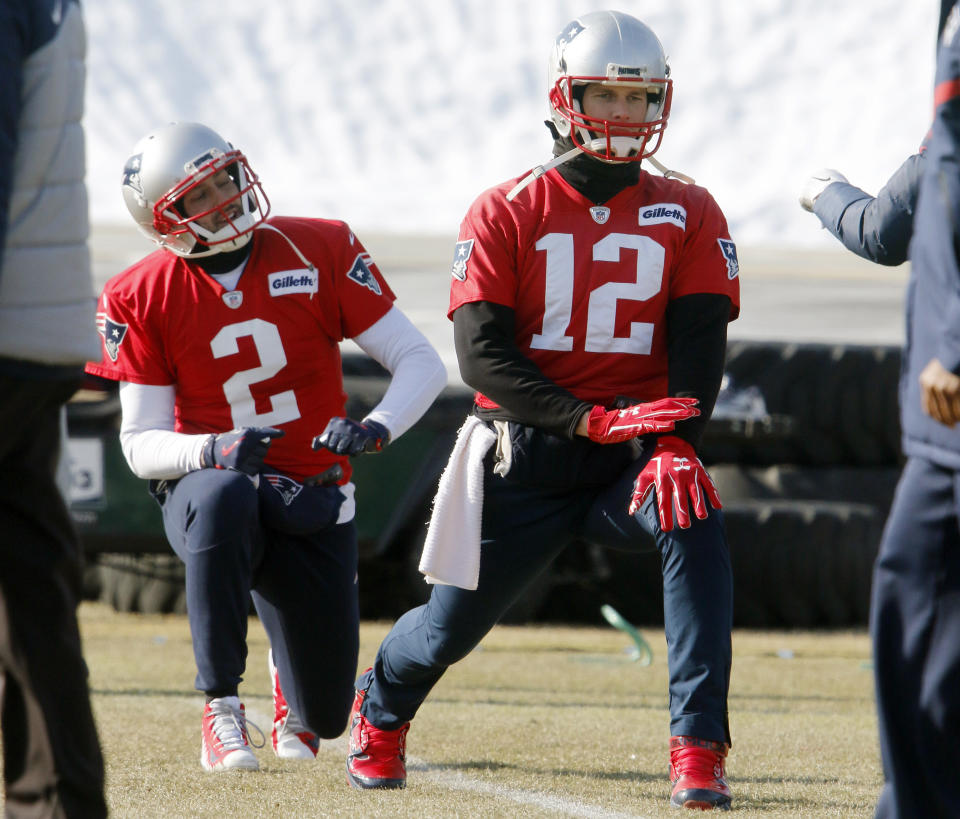 New England Patriots quarterbacks Tom Brady (12) and Brian Hoyer (2) warm up before practice Friday. (AP)