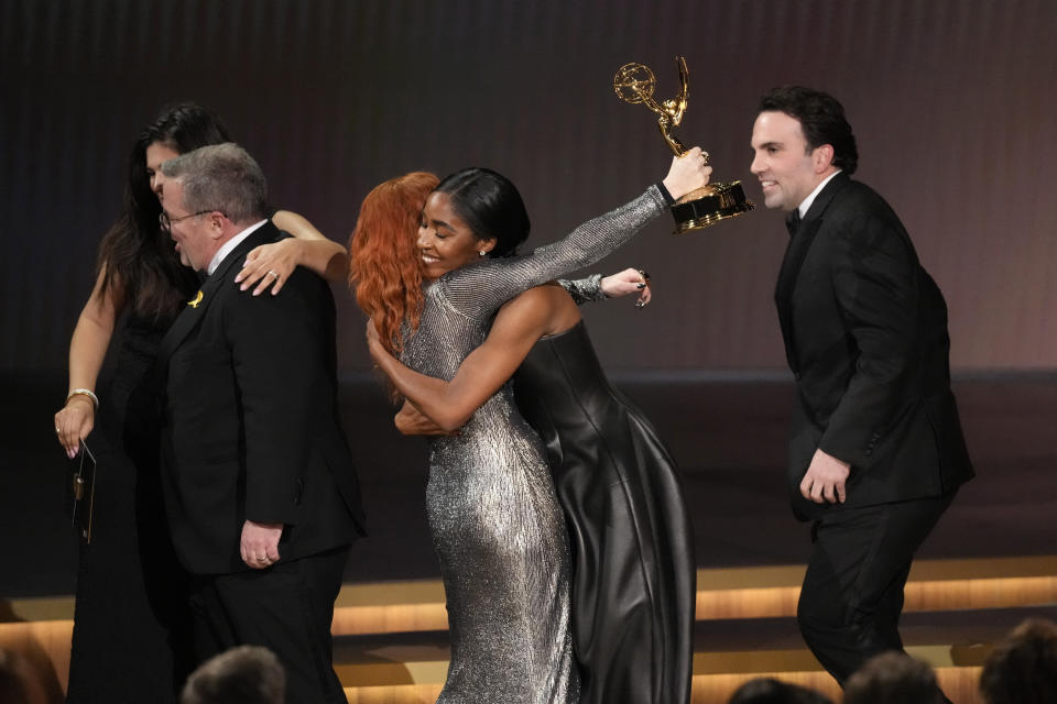 Natasha Lyonne, left, embraces Ayo Edebiri as she presents the award for outstanding comedy series for "The Bear" during the 75th Primetime Emmy Awards on Monday, Jan. 15, 2024, at the Peacock Theater in Los Angeles. (AP Photo/Chris Pizzello)