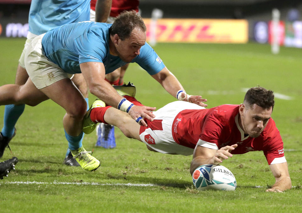 Wales' Tomos Williams scores a try during the Rugby World Cup Pool D game at Kumamoto Stadium between Wales and Uruguay in Kumamoto, Japan, Sunday, Oct. 13, 2019. (AP Photo/Aaron Favila)