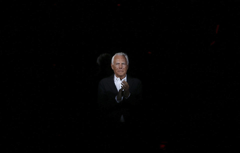 Italian fashion designer Giorgio Armani applauds the audience after presenting his Giorgio Armani men's Fall-Winter 2014 collection, part of the Milan Fashion Week, unveiled in Milan, Italy, Tuesday, Jan.14, 2014. (AP Photo/Luca Bruno)