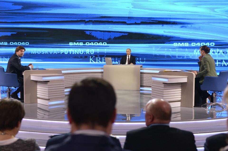 Russian President Vladimir Putin, background center, listens during a nationally televised question-and-answer session in Moscow on Thursday, April 17, 2014. Russia’s President Vladimir Putin on Thursday dismissed claims that Russian special forces are fomenting unrest in eastern Ukraine as “nonsense,” but voiced hope for success of four-way talks on settling the crisis. (AP Photo/RIA Novosti, Alexei Nikolsky, Presidential Press Service)