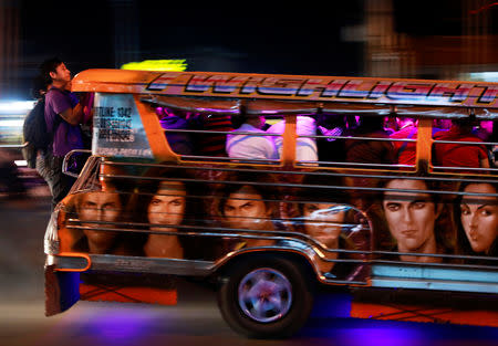 Commuters hang on to the back of a crowded jeepney in Cainta, Rizal, Philippines, February 1, 2019. REUTERS/Eloisa Lopez