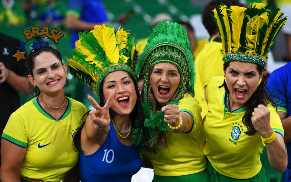 Fans of Brazil cheer prior to the FIFA World Cup 2022 quarter final soccer match between Croatia and Brazil at Education City Stadium - Neil Hall/Shutterstock